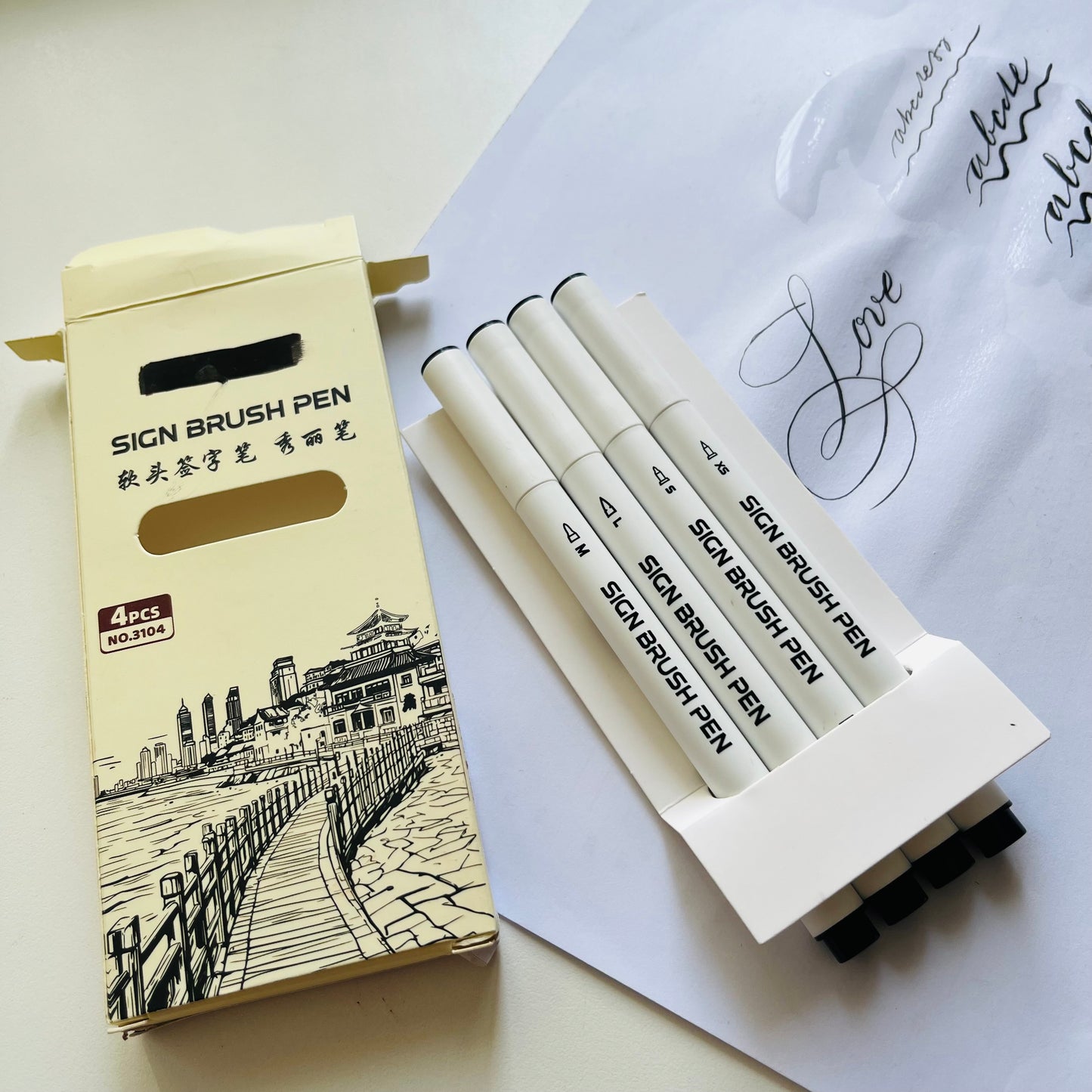 Set of sign brush pens with packaging on a white surface