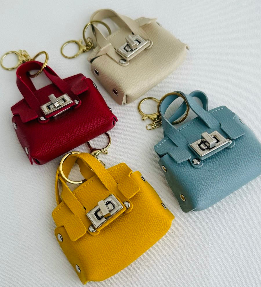 Set of colorful mini handbag keychains on a white background